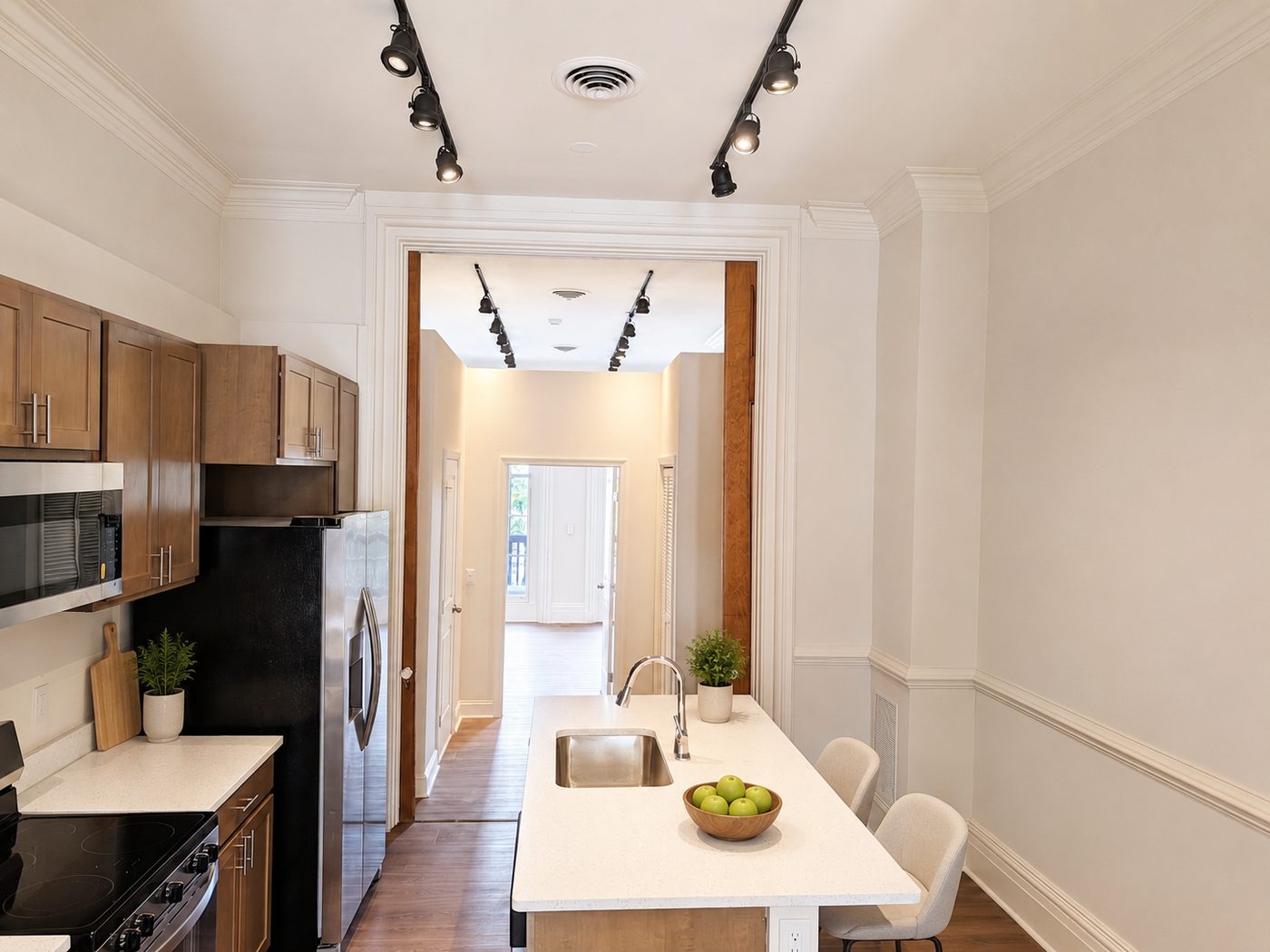 Renovated kitchen with quartz island and stainless appliances